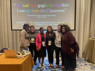 Six people standing in front of screen that reads Critical Pedagogies in Practice: Lessons from the Classroom