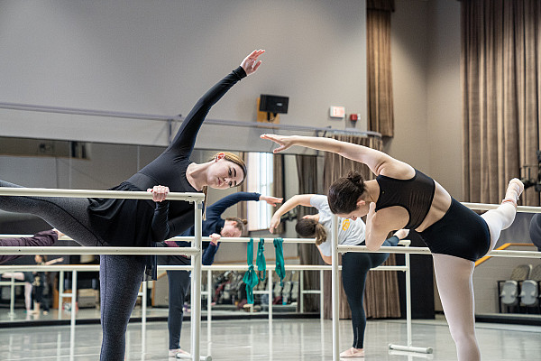 Students perform ballet combinations at the barre in the Rose L. Strasser Studio.
