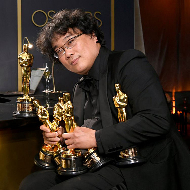 Bong Joon Ho with his multiple Oscars that he won for Parasite.