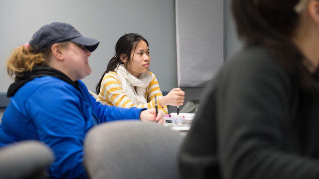 student listening to instructor