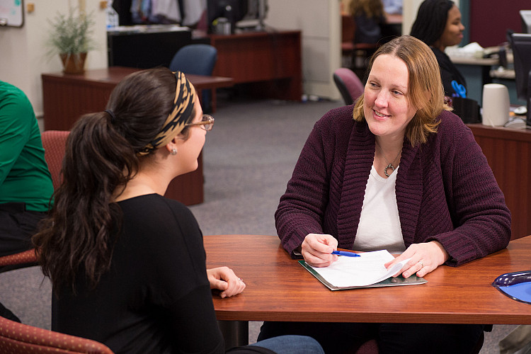 Staff Member helping a student