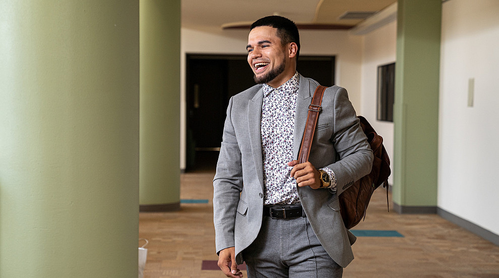 Student walking in the Seymour Union with professional attire on
