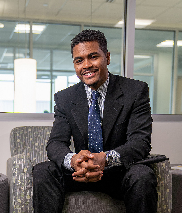 Business student sitting in a chair in the Academic Success Center