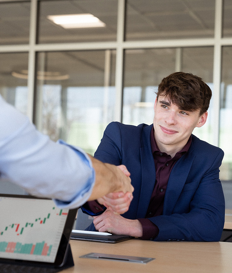 Business students shaking hands