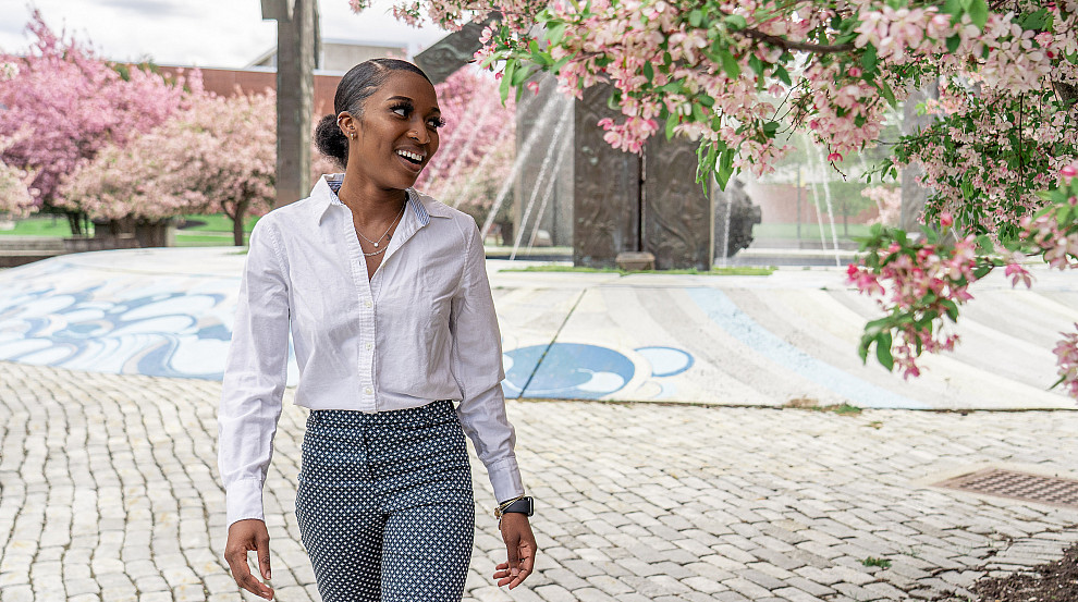 Student walking by the Special Olympics Fountain during the Spring semester