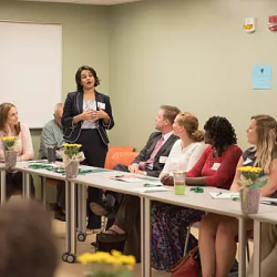 Graduate classroom filled with students listening to speaker