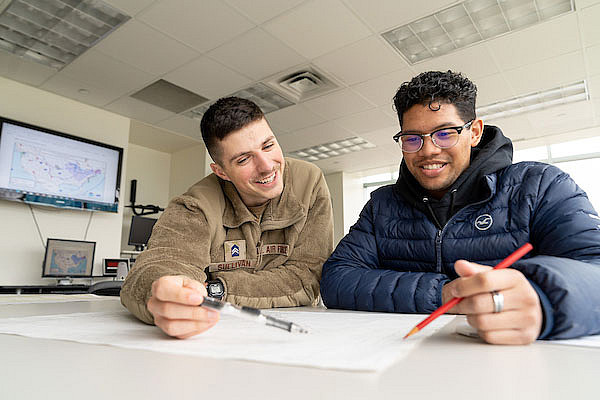 male graduate student tutoring a male student