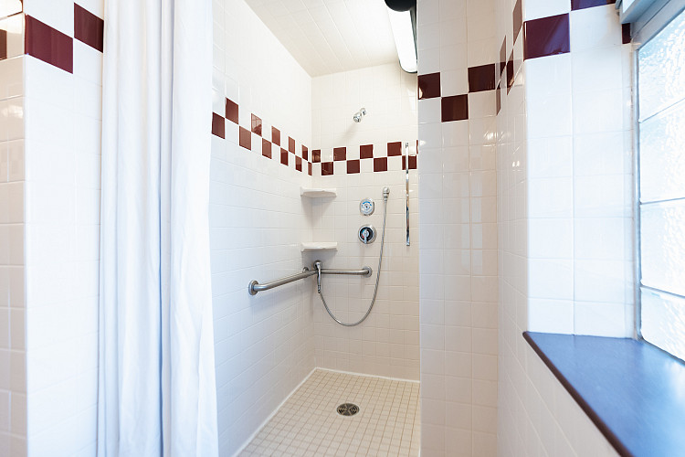 Close up of the shower stall of the corridor style bathroom