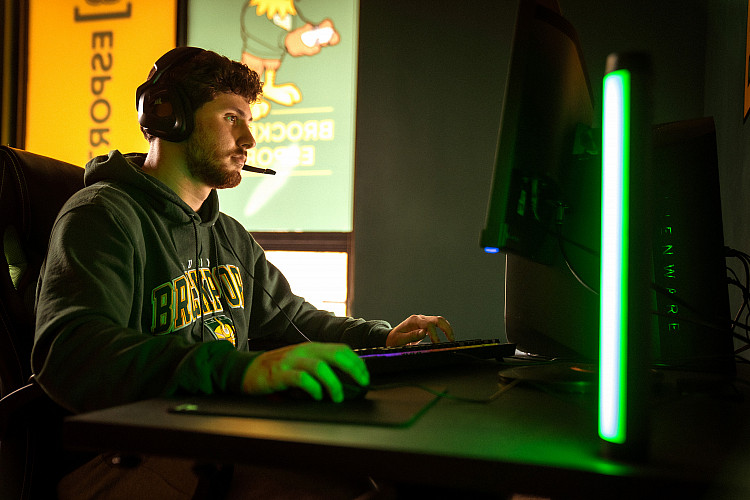 President of eSports club, Truman Benz, pictured at a computer with a headset on