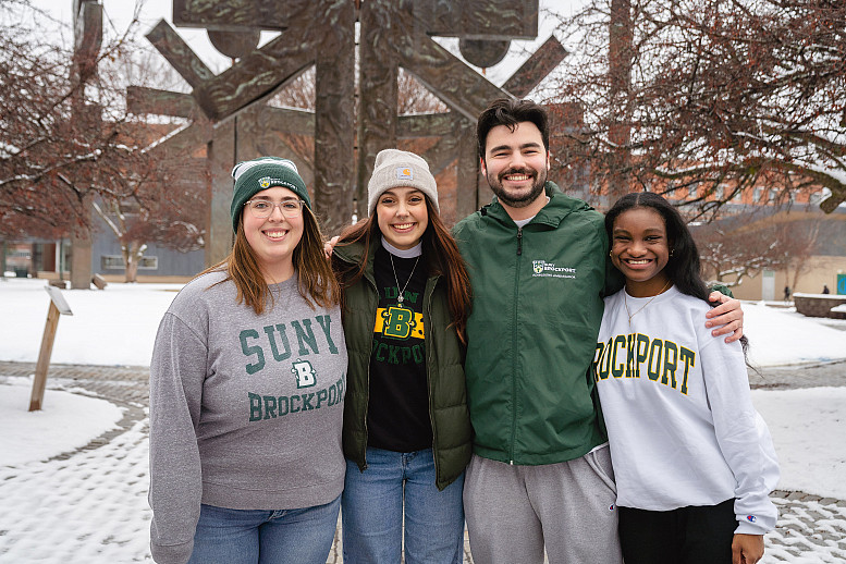 four resident assistants smiling together