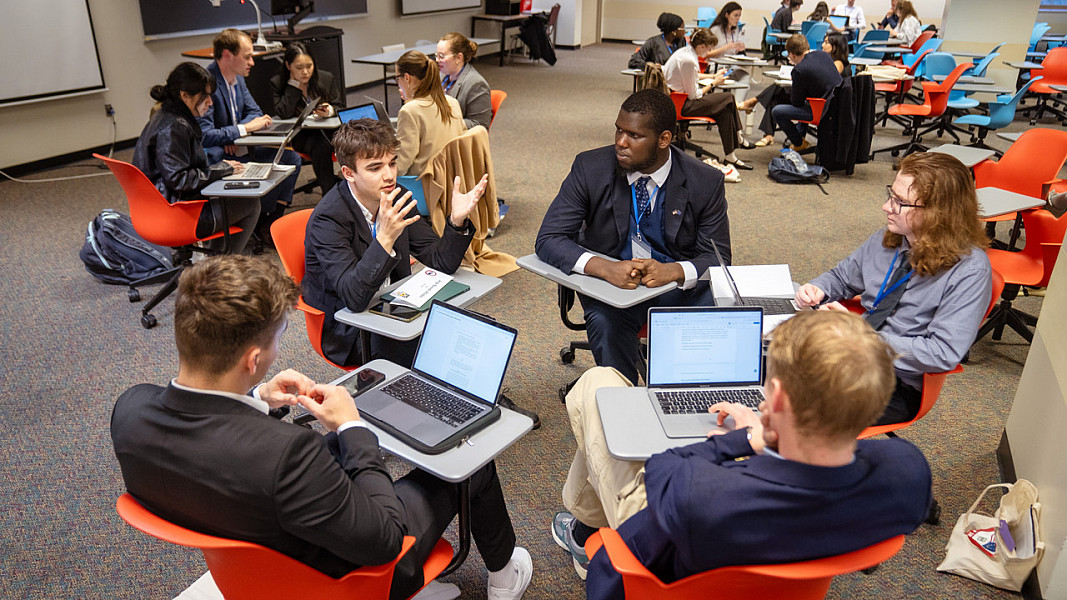Students discussing policy at EuroSim 2024 on the SUNY Brockport campus.