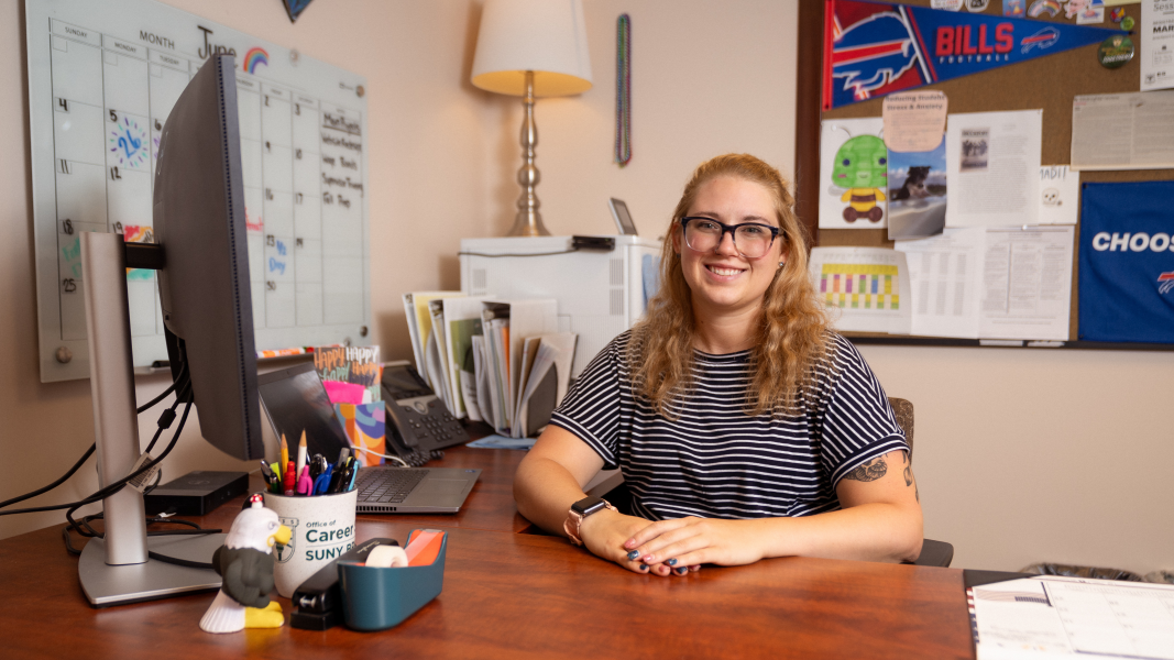 Madi Hiddie sitting at her desk in the Center for Career Design & Experiential Learning.