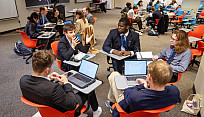 Students discussing policy at EuroSim 2024 on the SUNY Brockport campus.