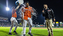 Alum Trevor Best interviewing minor league baseball players on Innovative Field in Rochester, NY.