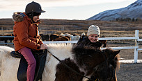 Ciara Murphy '25 assisting a camper with visual impairment in horseback riding.