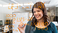 Alanna Pellicane writing equations on a clear board.