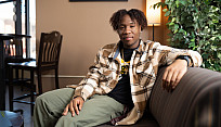 DaJuan Jackson sitting on a couch in the Jitterbugs Cafe.
