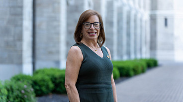 woman posing in green dress outside