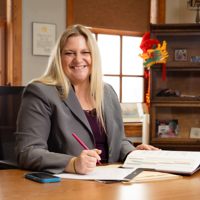 Rachael Tabelski sitting at a desk with a pen in her hand.