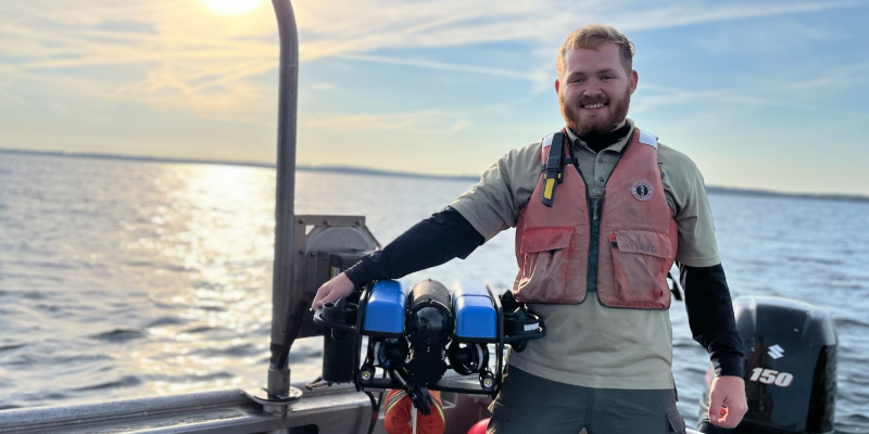 Kyle Morton, a SUNY Brockport Master of Science in Environmental Science and Ecology graduate, on a boat.