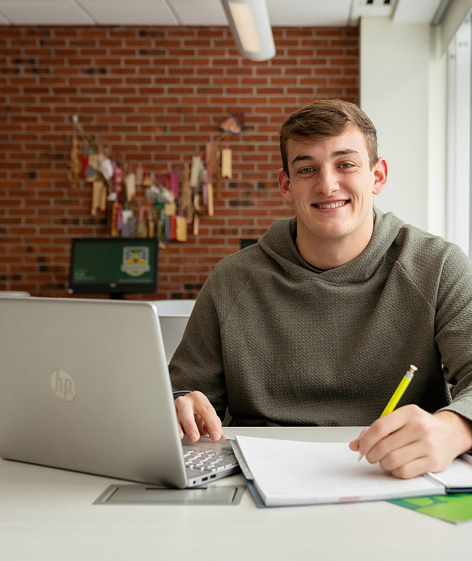 Justin Delvecchio studying on a laptop