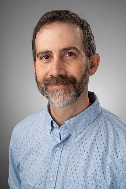 I middle aged Caucasian man with a beard.